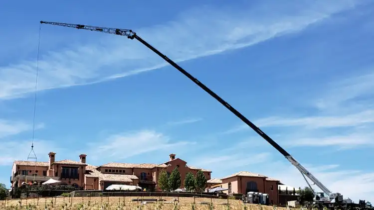 Setting stone columns and caps at a residence in Loomis, CA; using the jib for additional reach
