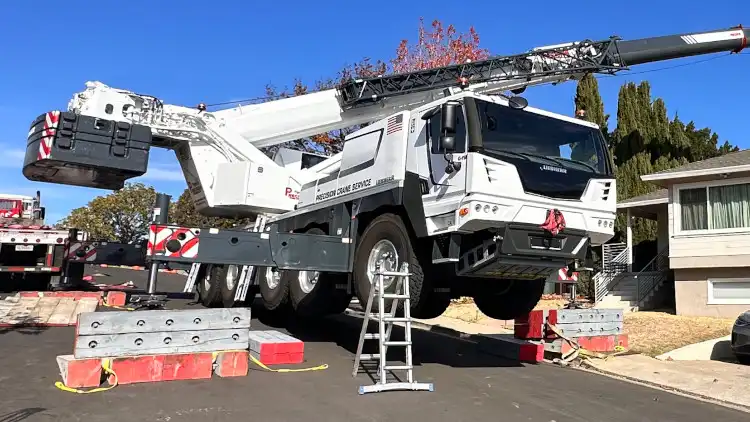 110 ton all-terrain crane sets a service pole in San Carlos, CA.